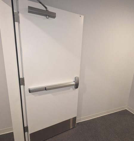 Professional commercial locksmith technician installing a high-security lock on a business door, providing fast, reliable, and efficient locksmith services for commercial properties.